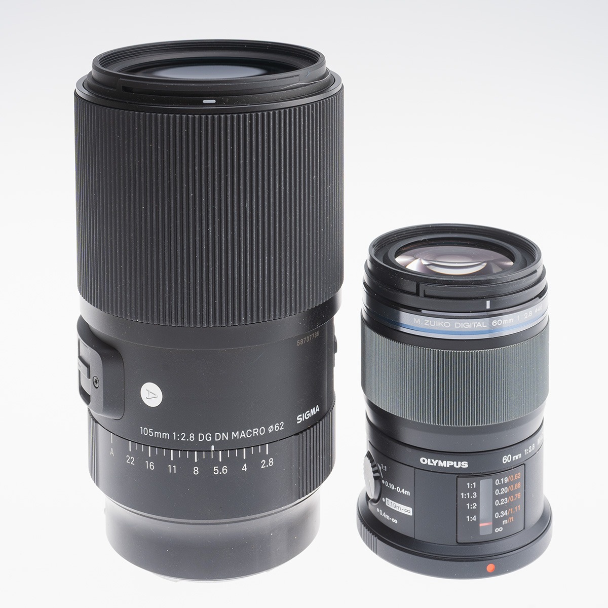 The OM-Systems 60mm f/2.8 M.Zuiko Macro, right, next to the Sigma 105mm F2.8 macro.for full frame. The Olympus is equivalent to a 120mm F2.8 in full-frame terms, but is significantly smaller and lighter.