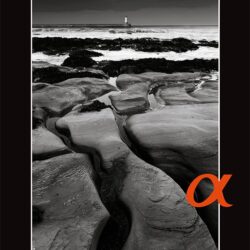 A black book cover with red text reading 'photoworld' and an inset monochrome image. Photoworld was pub;ished to continue the Minolta Club's relationship with photographers after Sony acquired the Minolta camera business.